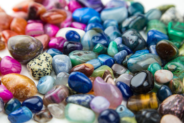 Fototapeta na wymiar various tumbled bright coloured semi precious gemstones