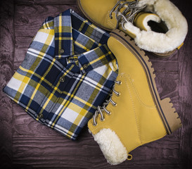 shoes with fur and a shirt in a cage on a wooden surface