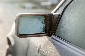 Car passenger side of the frozen mirror. First frost.