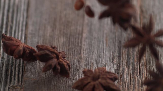 Falling star anise on wooden table. Shot with high speed camera, phantom flex 4K. Slow Motion.