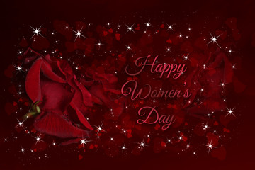 Red rose with drops of water on a red background with hearts in various shades of red and white stars and the words Happy Womens Day