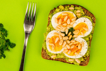 Boiled Egg on Crushed Avocado With Pine Nuts And Rye Bread Open Faced Sandwich
