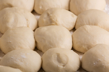 Fototapeta na wymiar Ball-shaped pieces of dough prepared for baking pies