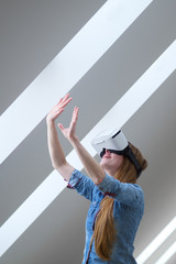 Fototapeta na wymiar redhead girl with virtual reality glasses