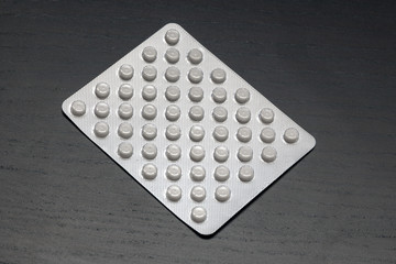 blister with pills on a dark background