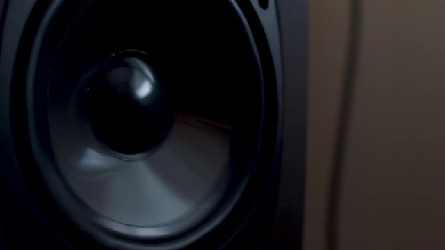 We start out of focus on a tower speaker and move in to an in focus woofer pounding.
