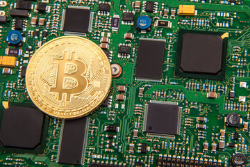 gold coin bitcoin on a green board with microchips