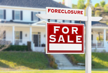 Left Facing Foreclosure For Sale Real Estate Sign in Front of House.