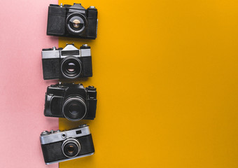Vintage Film Cameras On Yellow And Pink Background. Creativity Retro Technology Concept