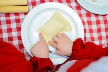 children cook a cheese patty with their own hands