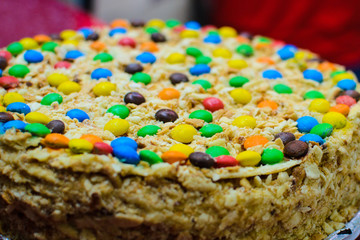 cake close-up decorated with sweets of different colors