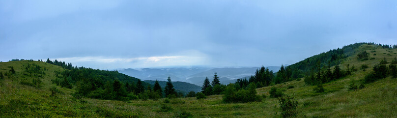 Naklejka na ściany i meble Amazing panorama on the mountain Yavorinka in the Carpathians during the rain