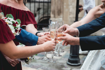 People hold in hands glasses with white wine. wedding party.
