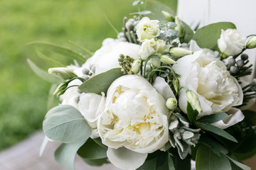 wedding bouquet with rain drops. Morning at wedding day at summer. Beautiful mix white peonies and eucalyptus