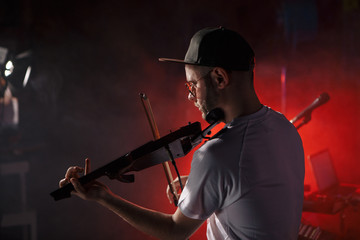 Close-up photo of man playing electric violin