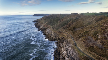 Fototapeta na wymiar Editorial SWANSEA, UK - JANUARY 26, 2018: Wales Coastal Path, a long-distance footpath which runs along the majority of the coastline of Wales seen here as it stretches from Langland Bay to Caswell