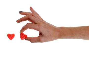 Jelly heart candy sweets in hand on white background isolation