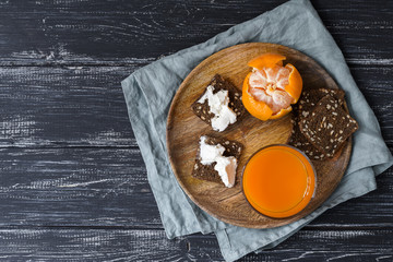 Carrot juice and rye crackers with cheese, a healthy breakfast. Top view, space for text.