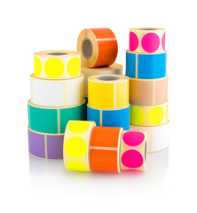 Colored label rolls isolated on white background with shadow reflection. Color reels of labels for...