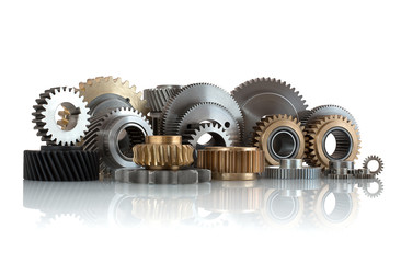 Sets of gears, cogwheels made of steel and brass isolated on white background with shadow reflection. Helical and spur gears,some with bearing isolated on white background with shadow reflection.