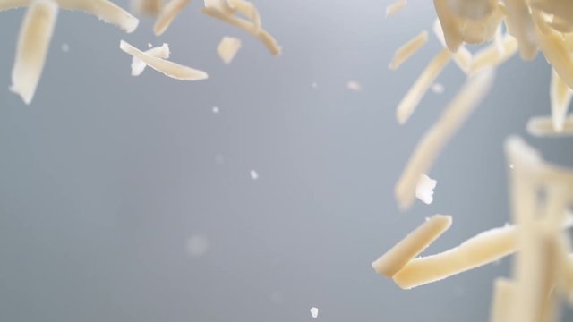 Flying grated mozzarella cheese in the air. Shot with high speed camera, phantom flex 4K. Slow Motion.