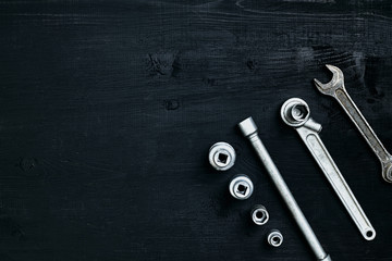 Tools for car repair in Workshop. Car repair equipment on black wooden background in car repair shop