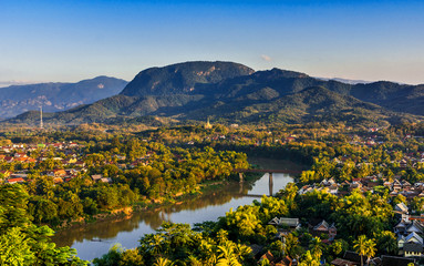 Luang Prabang, Laos, Southeast Asia: Landscape view over the city in the sunset lights from Mount Phousi, a sacred mountain located in the heart of the former capital of Laos - 189795064