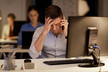 businessman calling on sartphone at night office