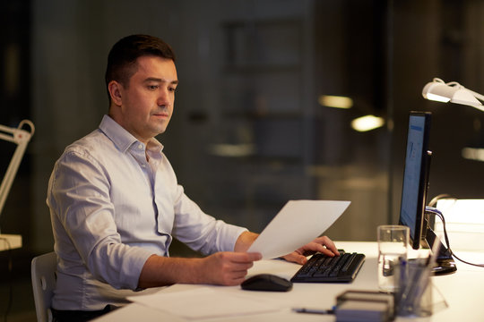 businessman with computer working at night office