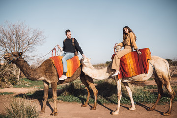 Young couple riding on camel