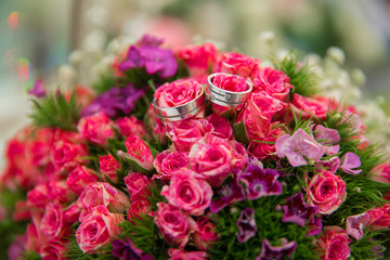 Pink wedding bouquet of flowers . Wedding bouquet with pearls and rings . Wedding bouquet made of pink Roses and rings . Selective focus.