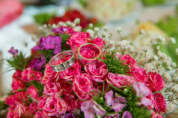 Pink wedding bouquet of flowers . Wedding bouquet with pearls and rings . Wedding bouquet made of pink Roses and rings . Selective focus.