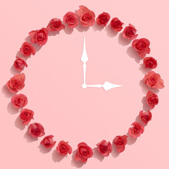 Rose flower clock on pink background, Floral blossom flat lay