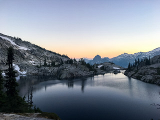 last light of mountains beyond lake at sunset