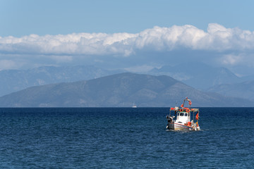 Alone fishing boat on blue sea.