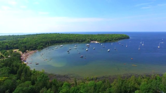 Door County peninsula flyover with beach and boats, Wisconsin summer