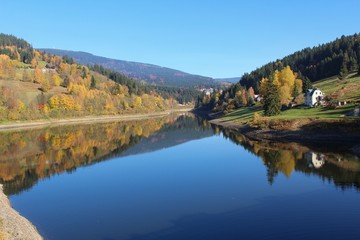 Autumn landscape view with pond in Spindleruv Mlyn, Czech Republic
