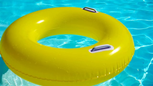 Swimming pool with a brightly yellow inflatable ring