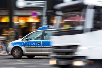 german police car speeding in city traffic