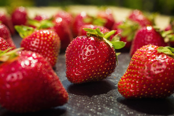 strawberries on stone background, delicious first class organic fruit as a concept of summer vitamins