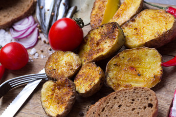 Baked potatoes with anchovies, pickled cucumbers, onions, black bread, tomatoes, chili peppers.