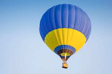 Garden poster Air sports Colorful of hot air balloon with fire and blue sky background
