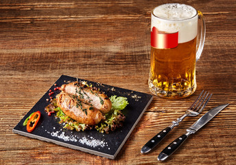 Grilled sausages with beer on wooden table. Top view.