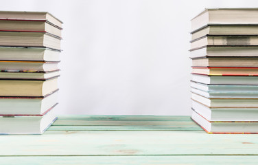 Pile of various books on wooden background