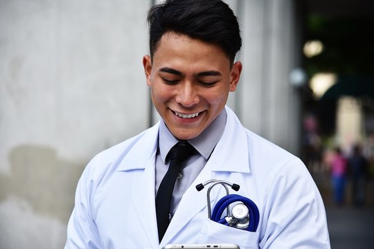 Adult Male Doctor Reading Tablet