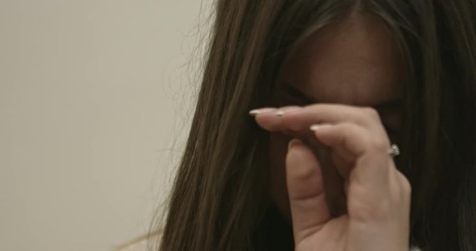 Cute girl caught cold. Sick woman with sinus pain on sofa holding hand on head