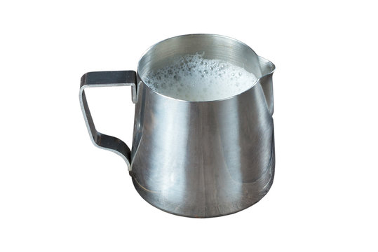 pitcher/ Metallic pitcher barista with milk on white background. Isolated