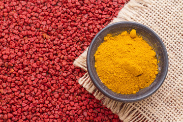 turmeric powder on achiote seeds