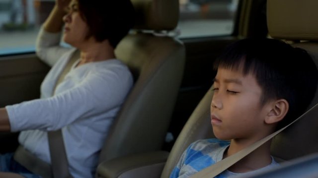 Mom and son  in a car during traffic in bangok