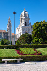 Fototapeta na wymiar The view of Church of Santa Maria through the garden of Empire square. Lisbon, Portugal